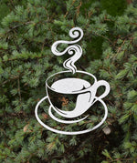 Load image into Gallery viewer, Discover artisanal charm with our hammered silver-painted steel cutout of a steaming coffee cup, perfect for elevating your home decor. This unique coffee-themed art piece adds a touch of elegance and warmth to any space. Ideal for coffee enthusiasts and interior design aficionados alike.
