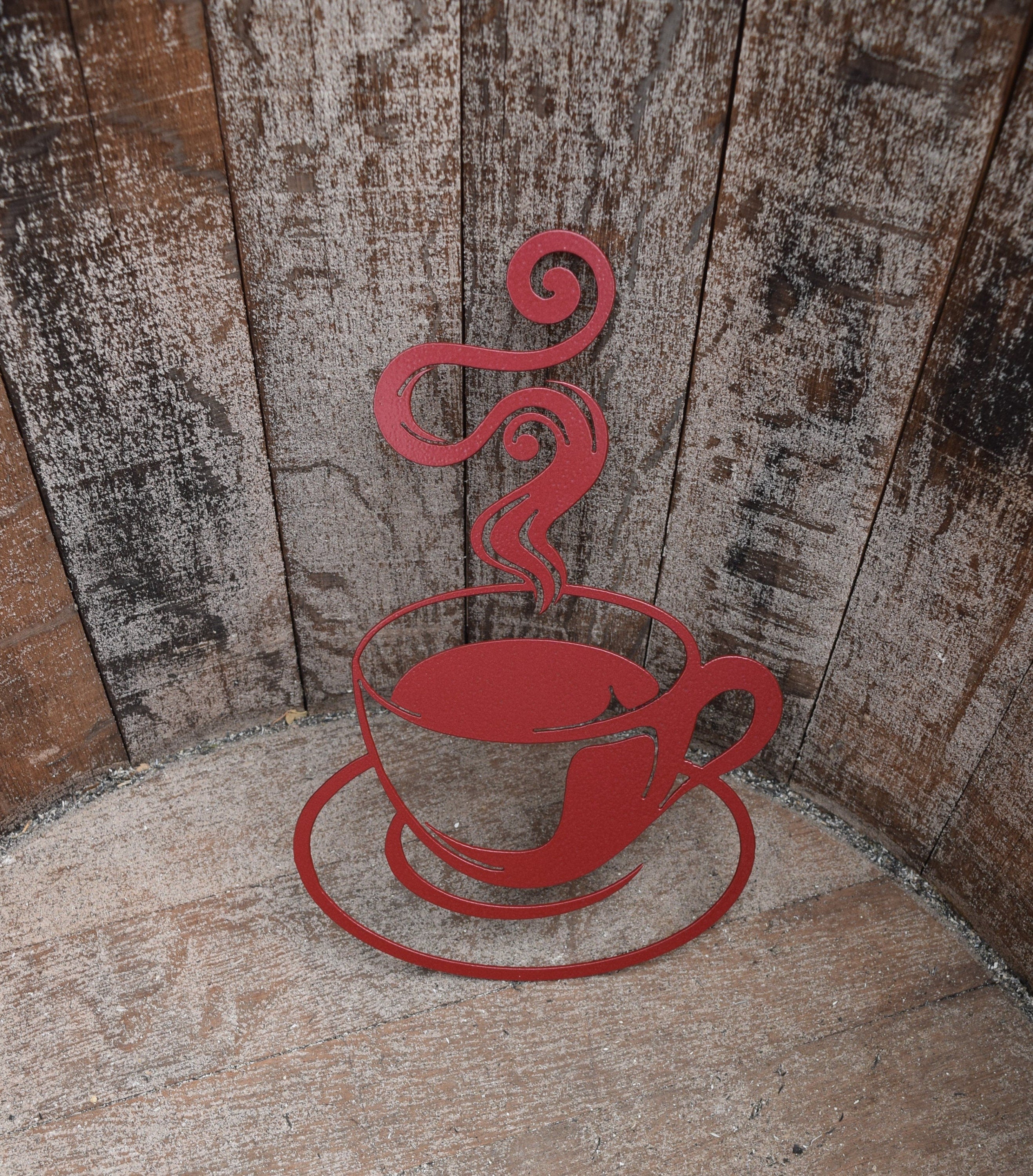 Enhance your outdoor space with a captivating hammered red painted steel cutout of a steaming coffee cup, adding warmth and charm to your garden or yard decor.