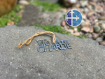 Load image into Gallery viewer, Patriotic metal ornament with rustic finish, laid near decorative stones.
