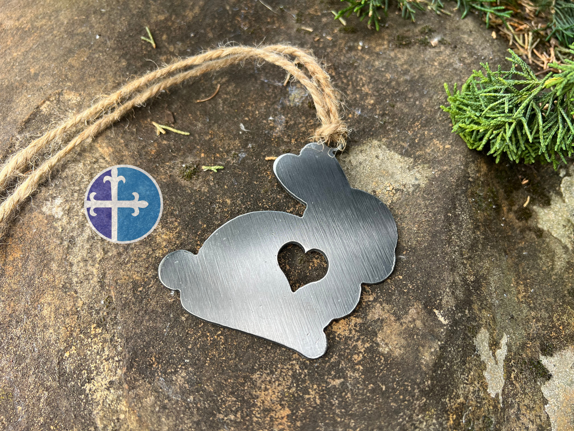 Close-up of a brushed metal bunny ornament with a heart cutout, perfect for Easter or spring decor.