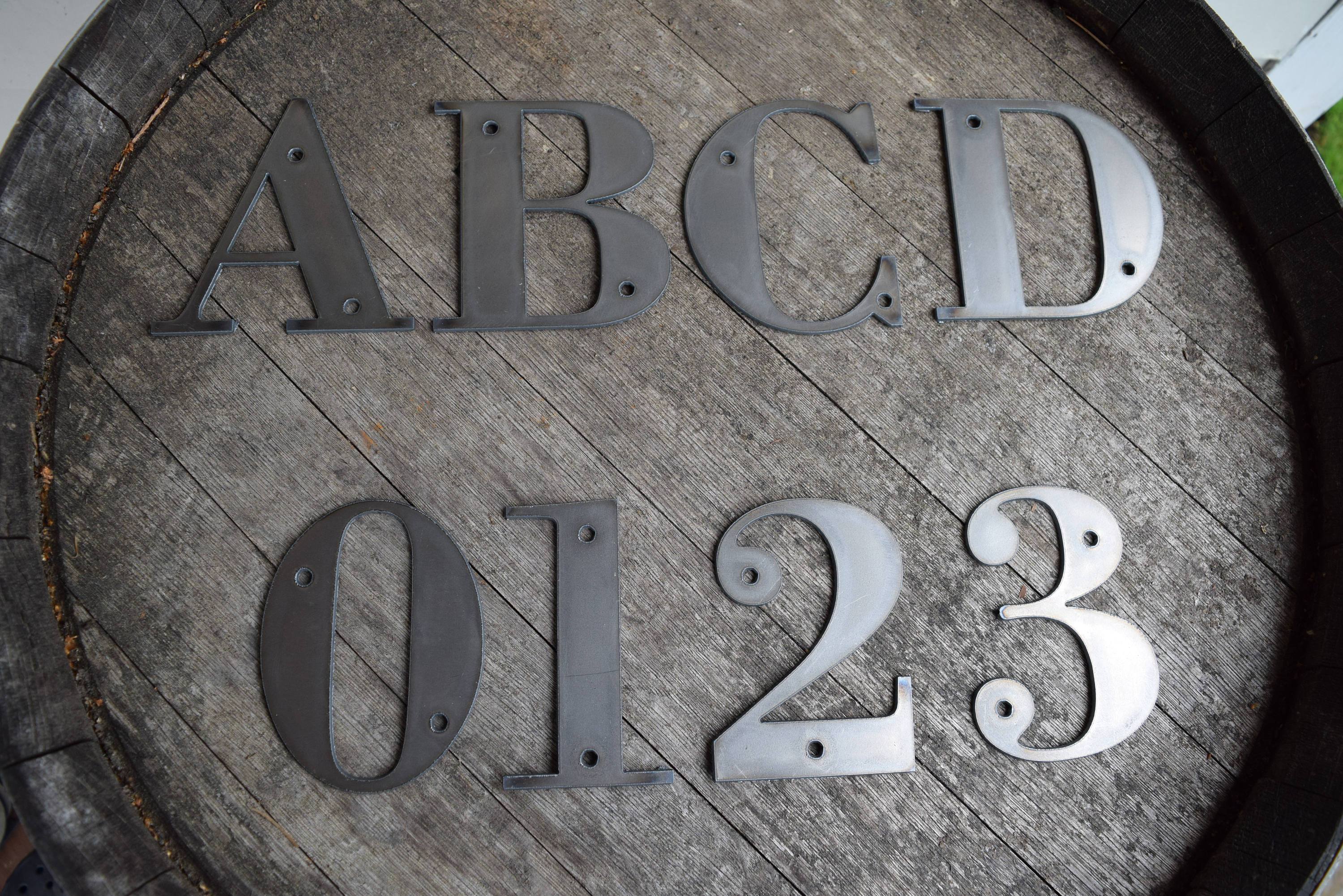 Frame alphabet font. Beveled metal letters and numbers with screws